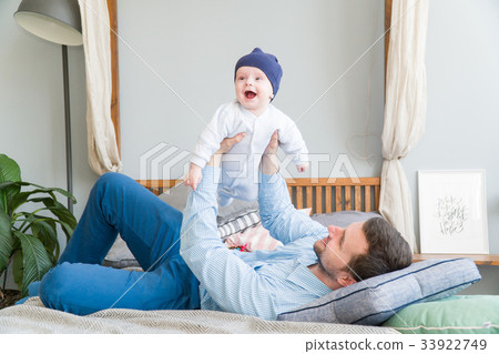 Close-up portrait of happy young father hugging Close-up portrait of happy young father hugging 33922749