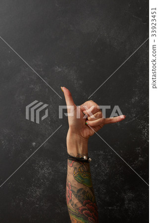 Beautiful woman's hand with tattoos 33923451