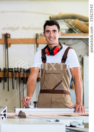 Carpenter or cabinet maker in his wood workshop Carpenter or cabinet maker in his wood workshop 33923543