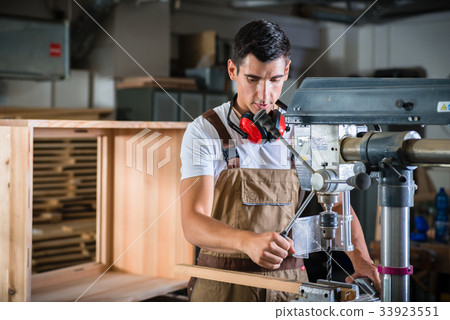 Cabinet maker working on power drill Cabinet maker working on power drill 33923551