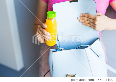 Young woman holding a bottle with juice 33924100