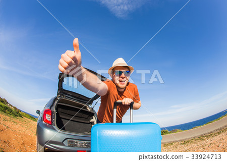 happy man enjoying road trip and summer vacation 33924713