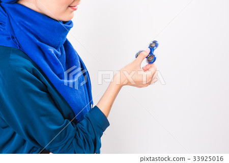 Close up of muslim girl holding and playing with 33925016