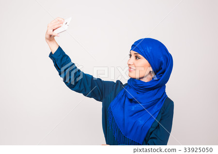 technology and people concept - muslim woman in 33925050