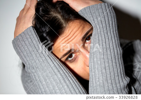 close up of unhappy woman crying on floor close up of unhappy woman crying on floor 33926828