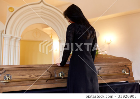 sad woman with coffin at funeral in church sad woman with coffin at funeral in church 33926903