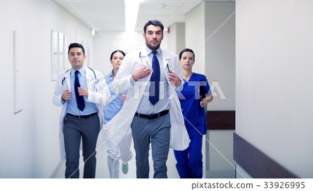 group of medics walking along hospital group of medics walking along hospital 33926995