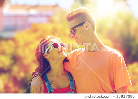 happy teenage couple looking at each other in park happy teenage couple looking at each other in park 33927096