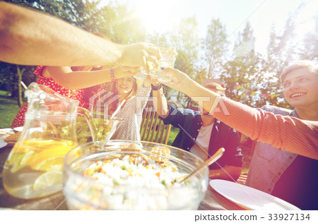 happy friends with drinks at summer garden party 33927134