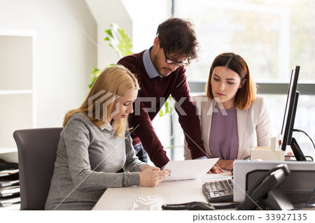 happy business team with papers in office 33927135