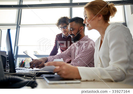 business team with laptop and coffee in office business team with laptop and coffee in office 33927164