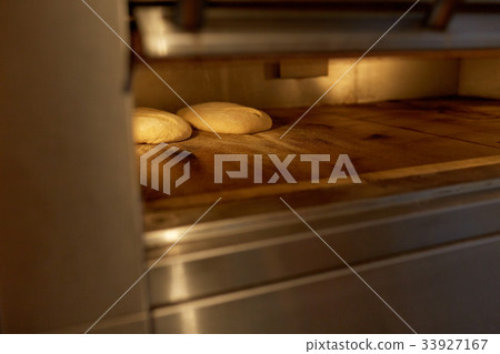 yeast bread dough in oven at bakery kitchen yeast bread dough in oven at bakery kitchen 33927167