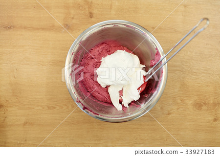 macaron batter with whipped egg whites in bowl 33927183