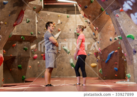 man and woman talking at indoor climbing gym man and woman talking at indoor climbing gym 33927899