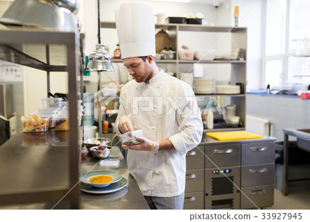 happy male chef cooking food at restaurant kitchen 33927945