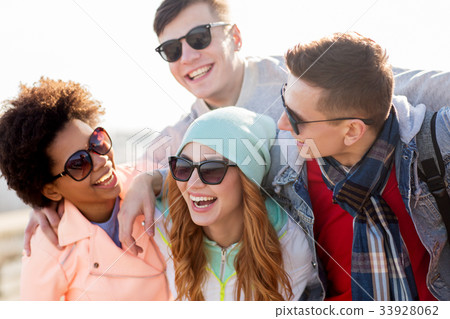 happy teenage friends in shades laughing outdoors happy teenage friends in shades laughing outdoors 33928062