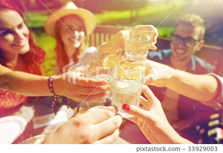 happy friends with drinks at summer garden party happy friends with drinks at summer garden party 33929003