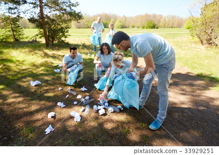 volunteers with garbage bags cleaning park area volunteers with garbage bags cleaning park area 33929251