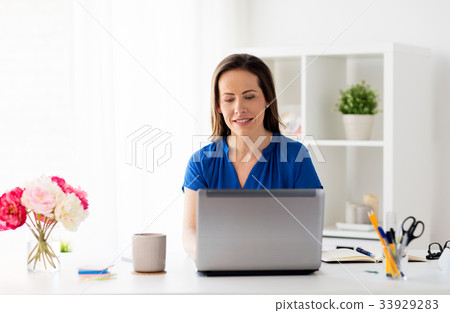 happy woman with laptop working at home or office happy woman with laptop working at home or office 33929283