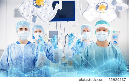 group of surgeons in operating room at hospital 33929287