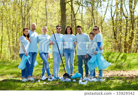 group of volunteers with garbage bags in park 33929342