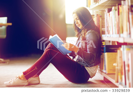 high school student girl reading book at library 33929839