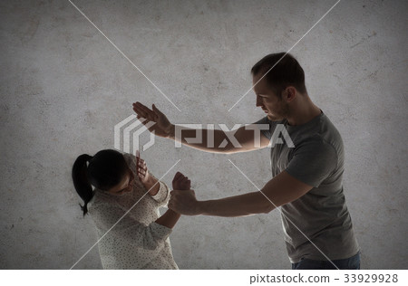 couple having fight and man beating woman 33929928