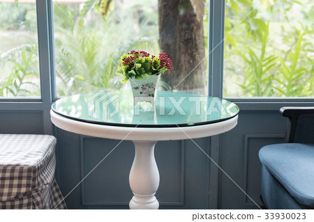 fabric armchair in living room in modern house beside window with garden view. home interior design fabric armchair in living room in modern house beside window with garden view. home interior design 33930023