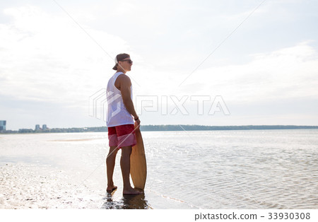 happy young man with skimboard on summer beach happy young man with skimboard on summer beach 33930308