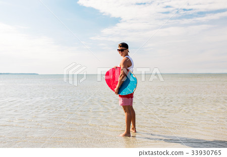 happy young man with skimboard on summer beach happy young man with skimboard on summer beach 33930765