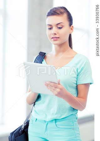 smiling student with tablet pc in college smiling student with tablet pc in college 33930766