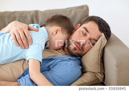 happy father and son sleeping on sofa at home happy father and son sleeping on sofa at home 33930945