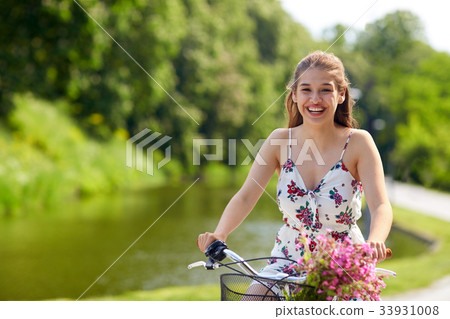 happy woman riding fixie bicycle in summer park 33931008