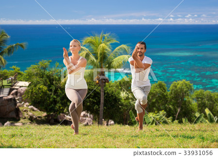 smiling couple making yoga exercises outdoors 33931056