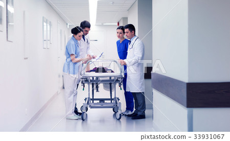 medics with woman on hospital gurney at emergency 33931067