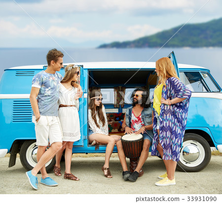hippie friends with tom-tom playing music over car 33931090