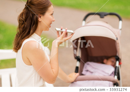 happy mother with smartphone and stroller at park happy mother with smartphone and stroller at park 33931274