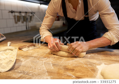 chef or baker cooking dough at bakery chef or baker cooking dough at bakery 33931275