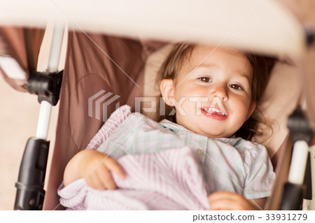 little child or baby lying in stroller outdoors little child or baby lying in stroller outdoors 33931279