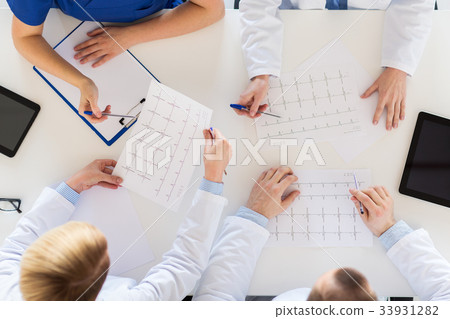 doctors with cardiograms and tablet pc at hospital 33931282