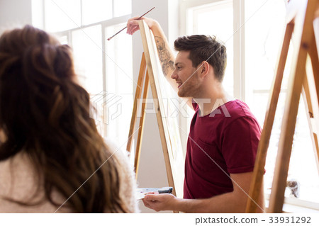 artists with easels painting at art school 33931292