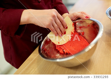 chef making macaron batter at confectionery chef making macaron batter at confectionery 33931293
