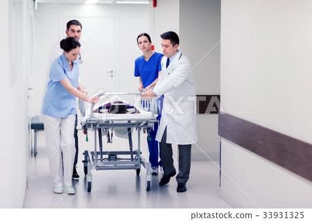 medics with woman on hospital gurney at emergency 33931325
