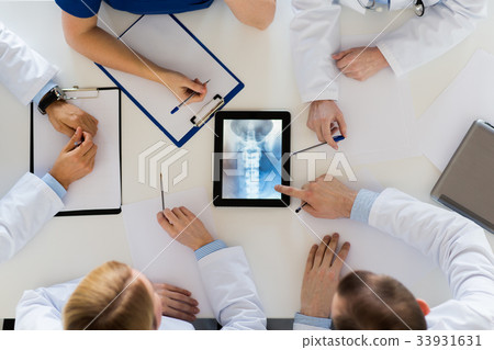 doctors with spine x-ray on tablet pc computer 33931631