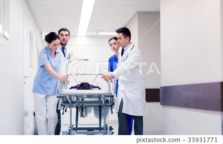medics with woman on hospital gurney at emergency medics with woman on hospital gurney at emergency 33931771