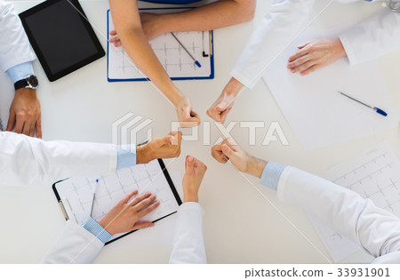 group of doctors showing thumbs up over table 33931901