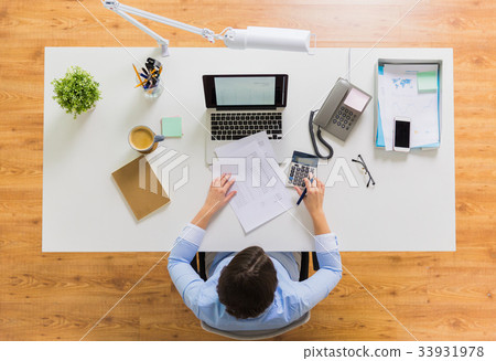 businesswoman with tax report at office businesswoman with tax report at office 33931978