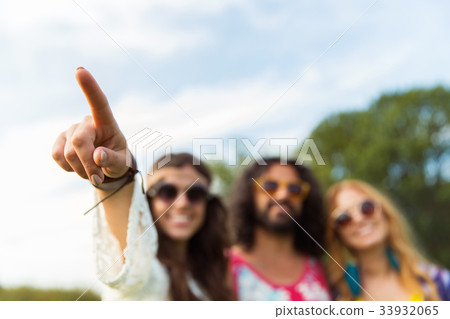happy hippie woman pointing finger outdoors happy hippie woman pointing finger outdoors 33932065
