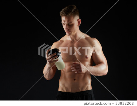 young man or bodybuilder with protein shake bottle 33932208