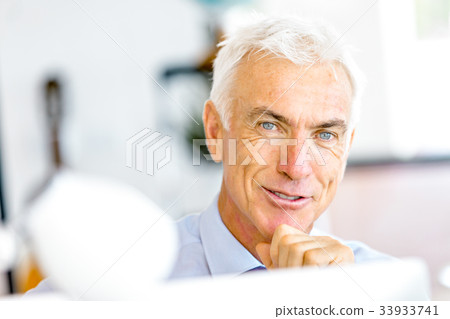 Businessman at the office Businessman at the office 33933741